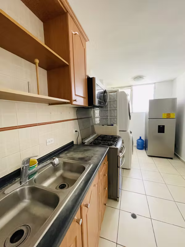 Cocina con fregador y refrigerador